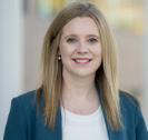 Faculty member with long blonde hair wearing blue blazer